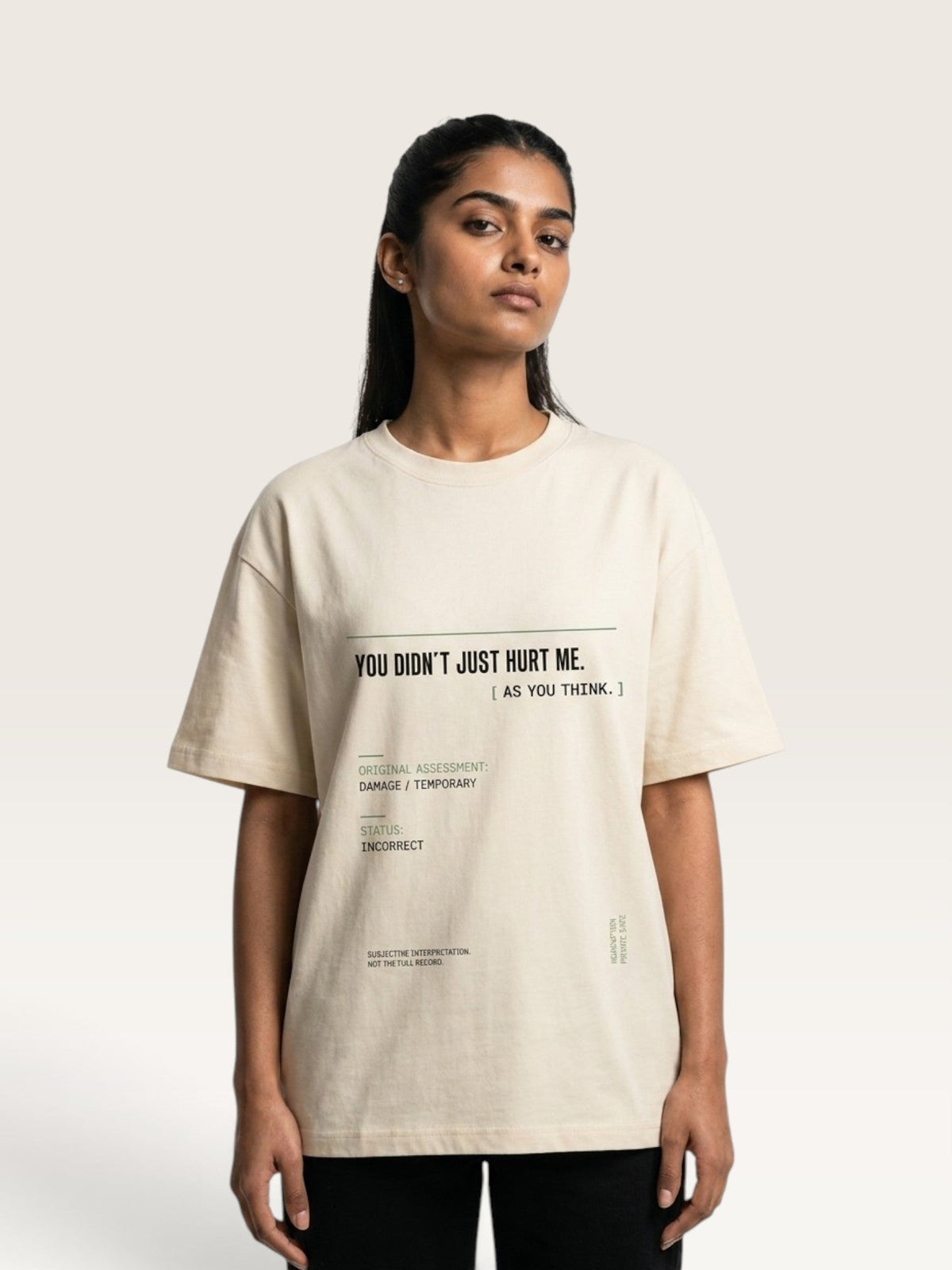 Mild Apricot - A woman modeling a cream-colored oversized graphic t-shirt with black text that reads 'YOU DIDN'T JUST HURT ME. [ AS YOU THINK.
