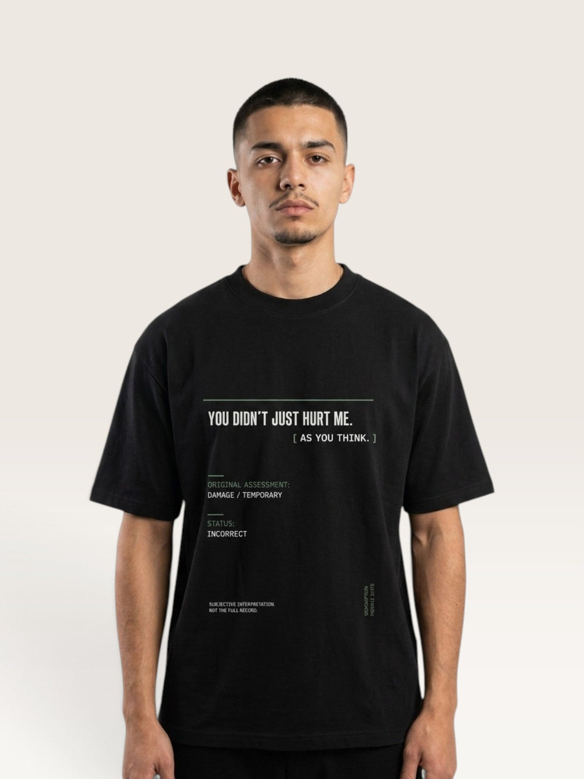 Black - short-sleeve t-shirt shown from the back, featuring a white typographic graphic with text and a minimalist terminal-style design on a light beige background.