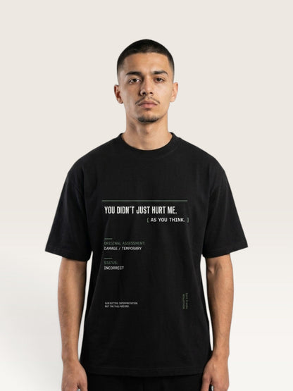 Black - short-sleeve t-shirt shown from the back, featuring a white typographic graphic with text and a minimalist terminal-style design on a light beige background.
