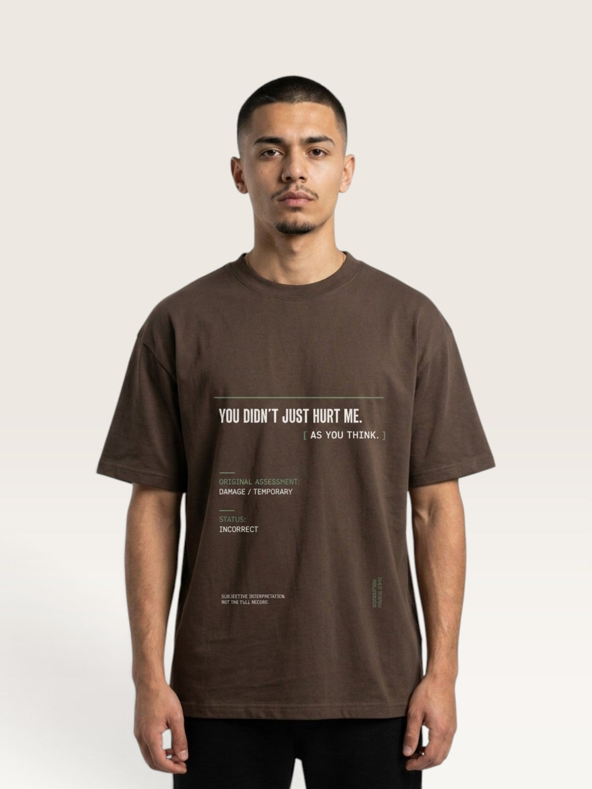 Coffee - A man wearing a brown graphic t-shirt with white text that reads 'YOU DIDN'T JUST HURT ME. AS YOU THINK.