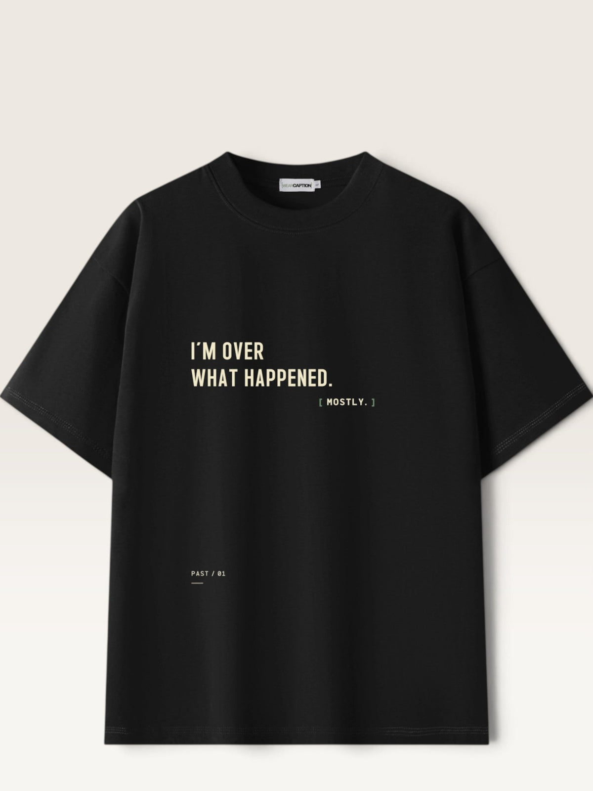 Black - heavyweight cotton oversized t-shirt with white I'M OVER WHAT HAPPENED graphic print on the front