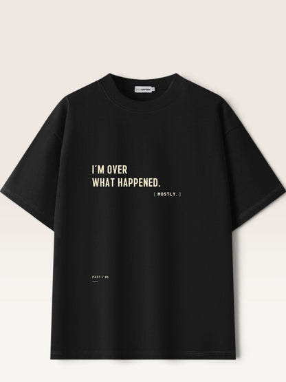 Black - heavyweight cotton oversized t-shirt with white I'M OVER WHAT HAPPENED graphic print on the front