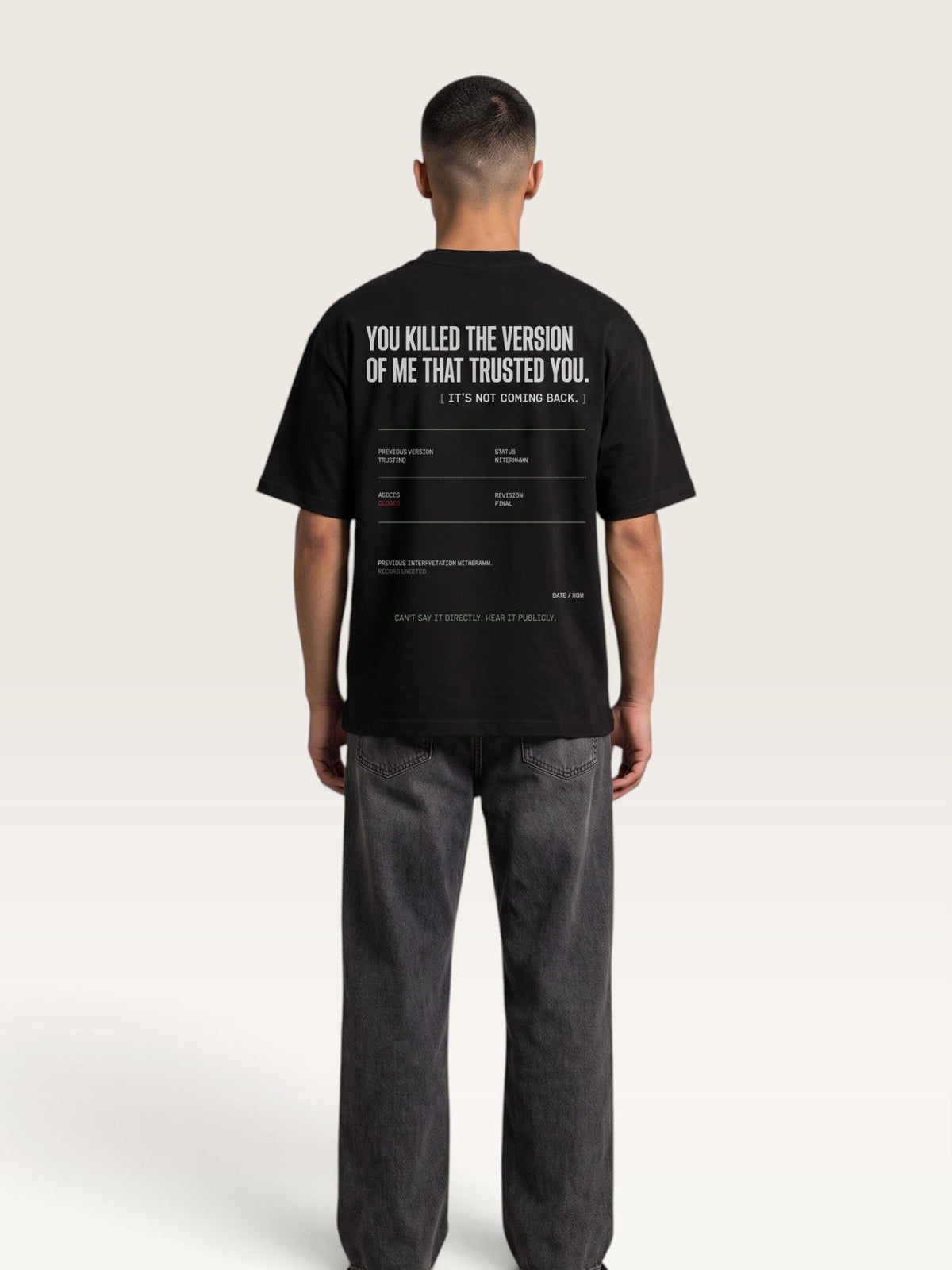 Black - short-sleeve t-shirt shown from the back, featuring a white typographic graphic with text and a minimalist terminal-style design on a light beige background.