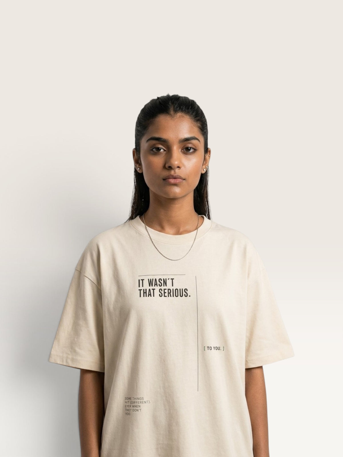 Mild Apricot WEARCAPTION oversized beige heavyweight cotton t-shirt with black IT WASN'T THAT SERIOUS graphic print on the front
