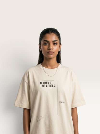 Mild Apricot WEARCAPTION oversized beige heavyweight cotton t-shirt with black IT WASN'T THAT SERIOUS graphic print on the front