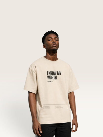 WEARCAPTION beige heavyweight cotton oversized t-shirt with I KNOW MY WORTH text print on a male model
