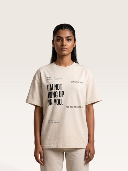 Mild Apricot A model wearing a WEARCAPTION beige heavyweight cotton oversized t-shirt with black graphic text on the front.