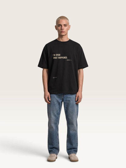WEARCAPTION black heavyweight cotton oversized t-shirt with I'M OVER WHAT HAPPENED graphic print on a male model