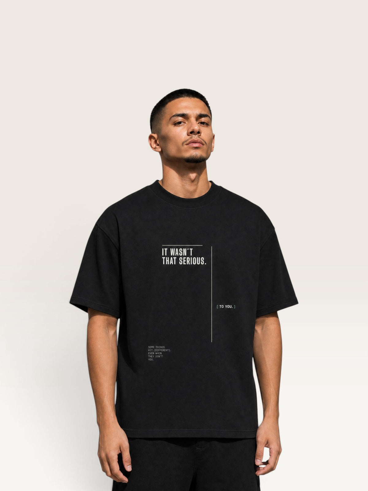 Black WEARCAPTION black heavyweight cotton oversized t-shirt with white graphic text print on the front chest.