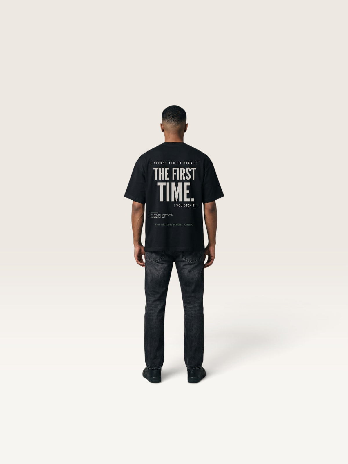 Black WEARCAPTION black heavyweight cotton oversized t-shirt with white typographic back print on a man from behind