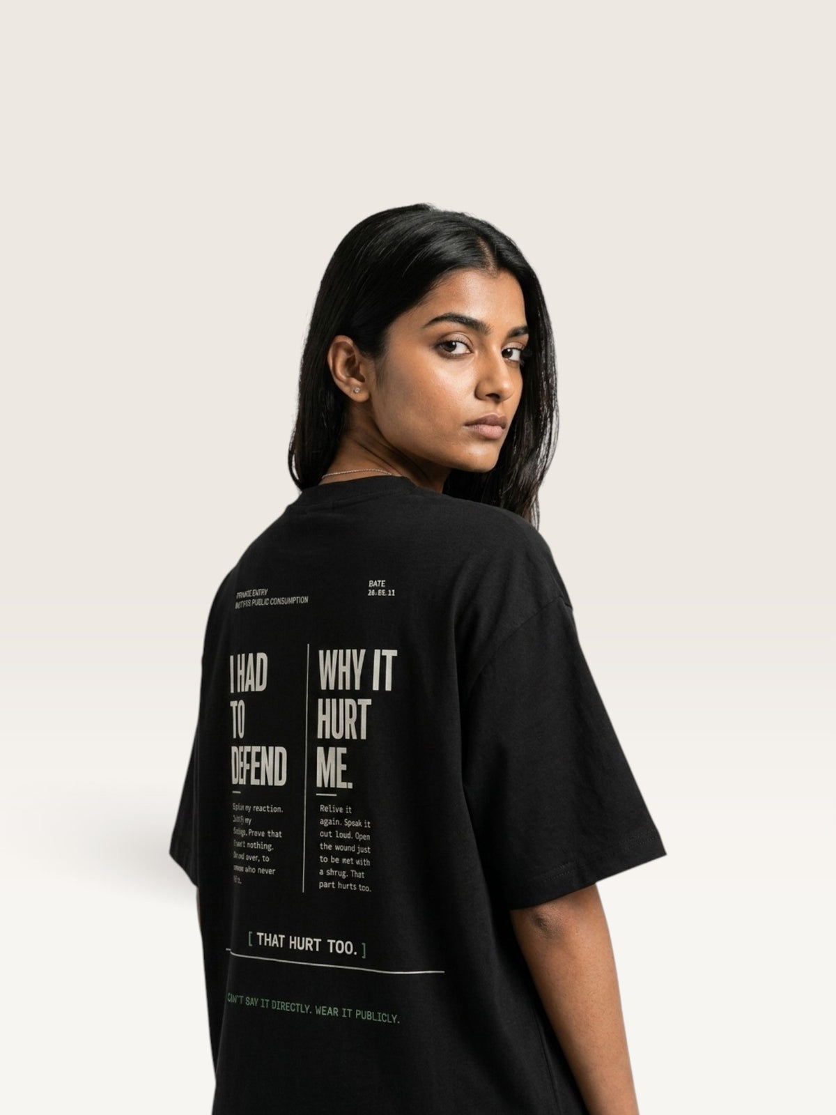 Black WEARCAPTION black heavyweight cotton oversized t-shirt with white graphic text on the back worn by a woman