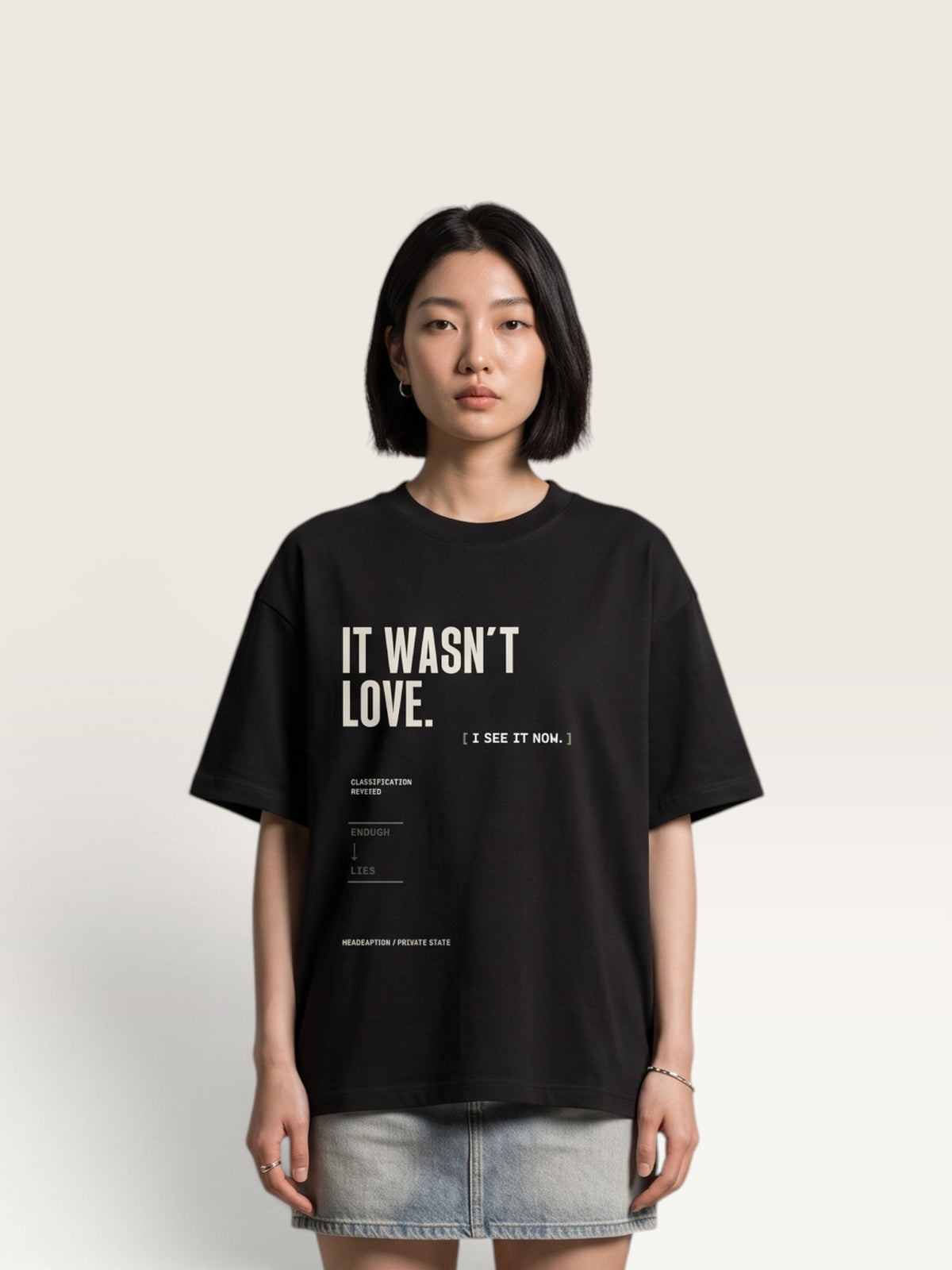 Black WEARCAPTION heavyweight cotton oversized t-shirt with white and green graphic text print on the back