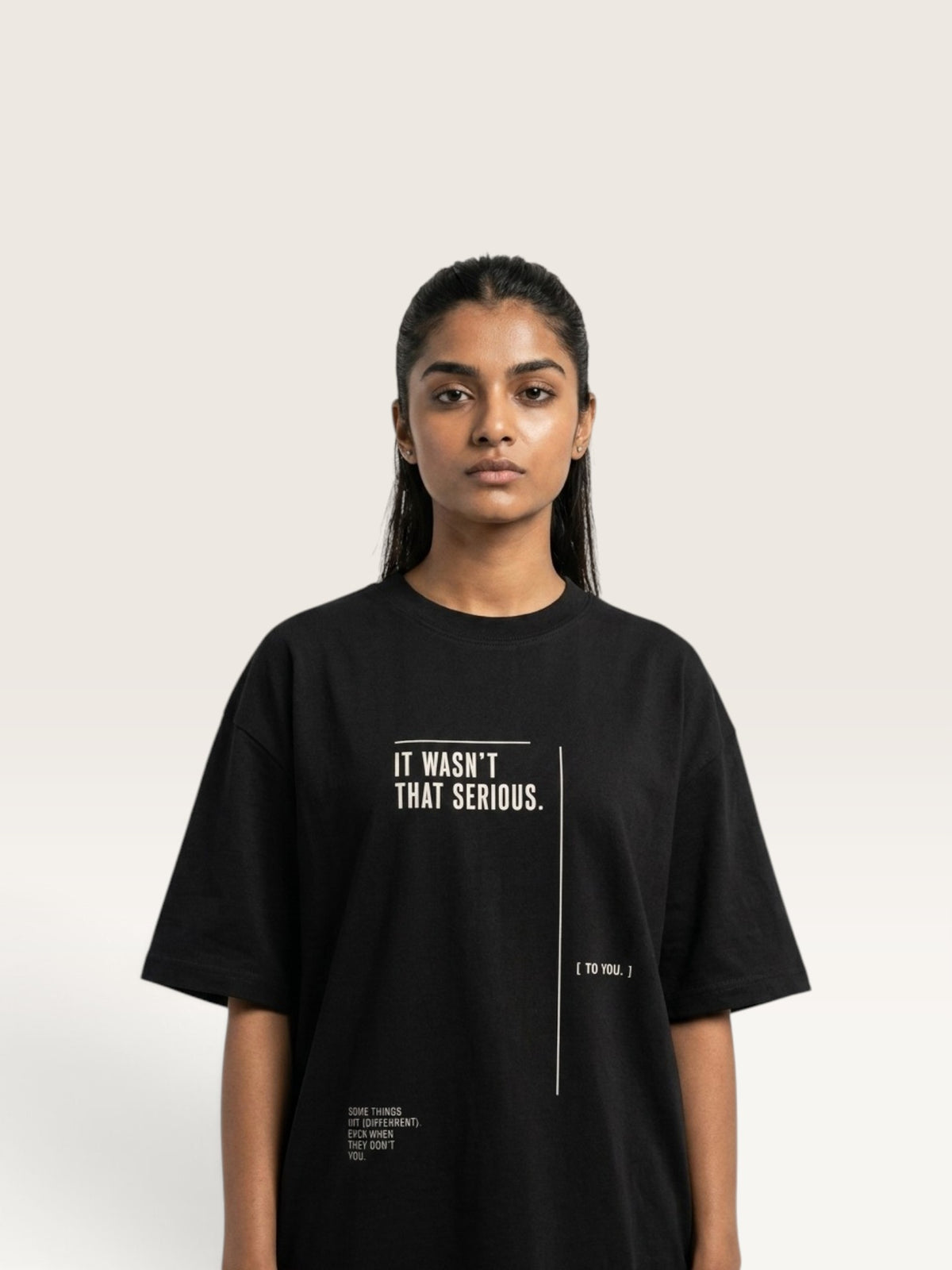 Black Model wearing a black WEARCAPTION heavyweight cotton oversized t-shirt with white graphic text on the front.