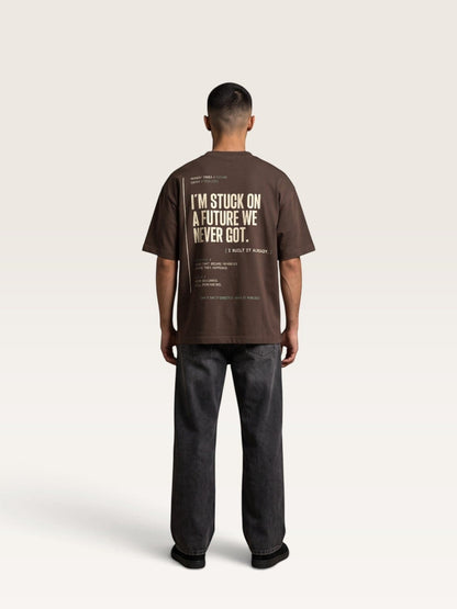 Coffee WEARCAPTION brown heavyweight cotton oversized t-shirt with back graphic text print worn by a man with black jeans