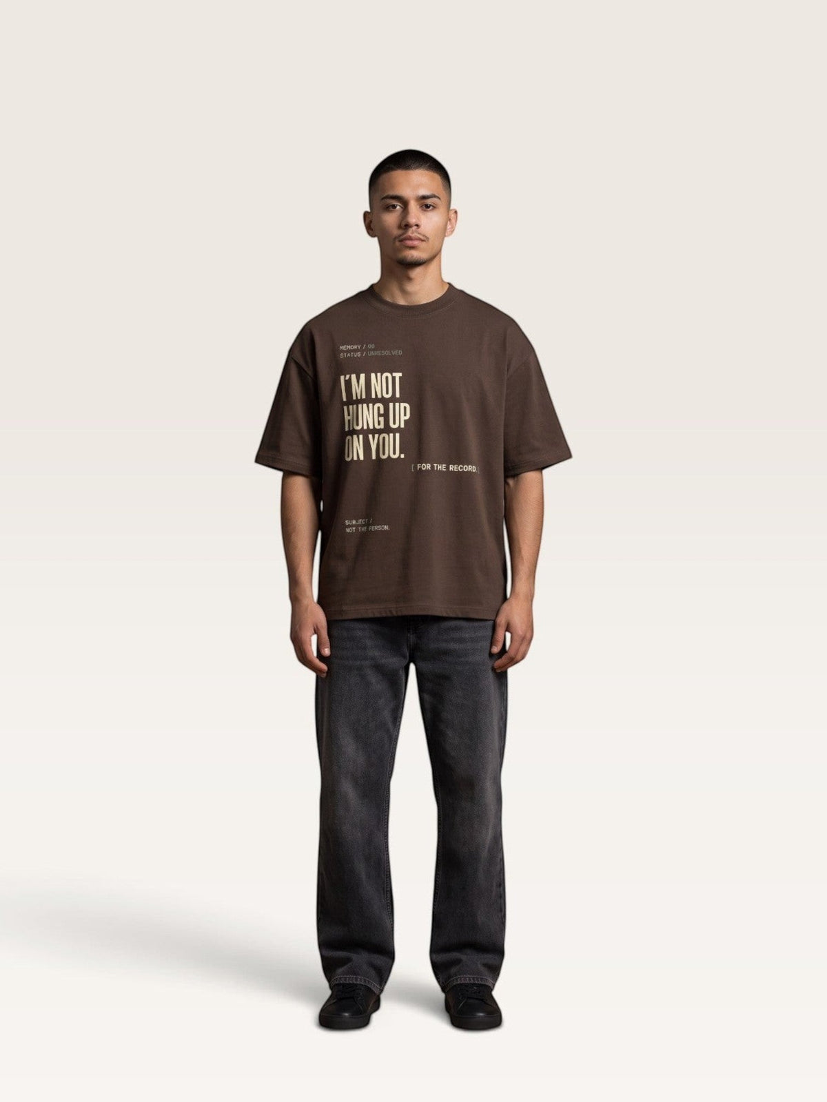 Coffee WEARCAPTION brown heavyweight cotton oversized t-shirt with graphic text print worn by a man with dark jeans
