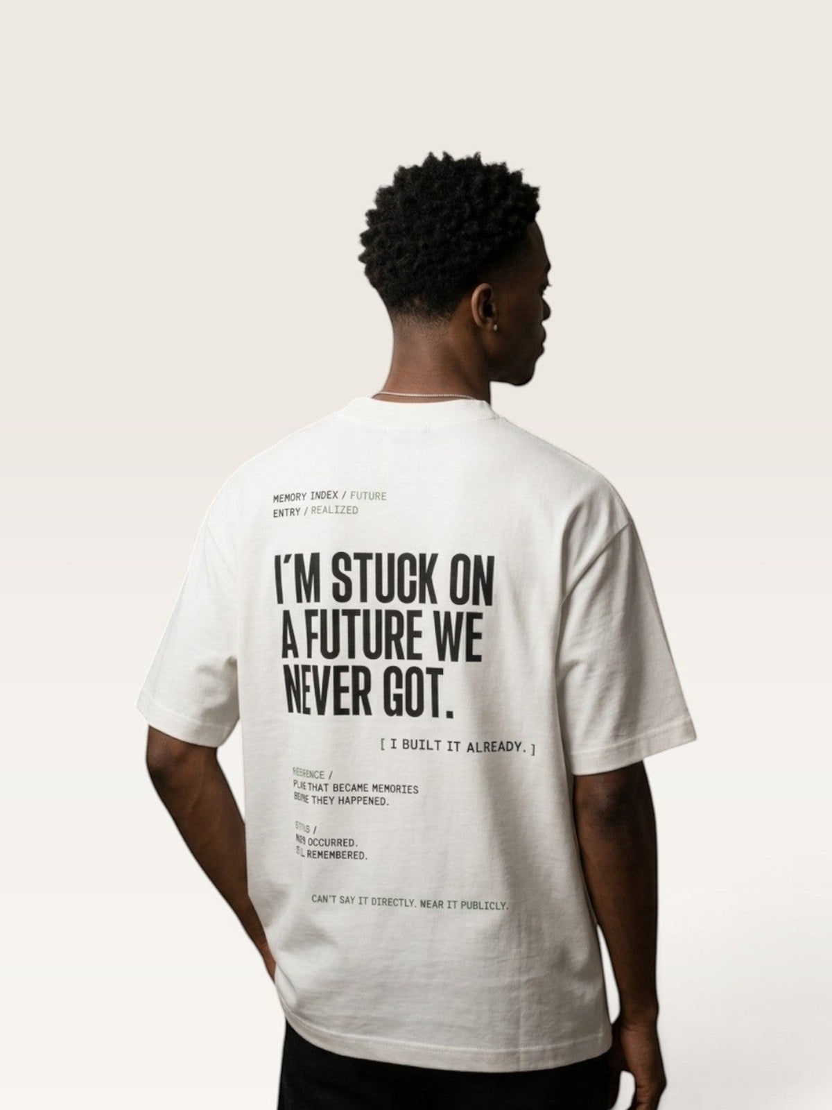 White  WEARCAPTION heavyweight white cotton t-shirt with black typographic back print on a model, oversized boxy fit.