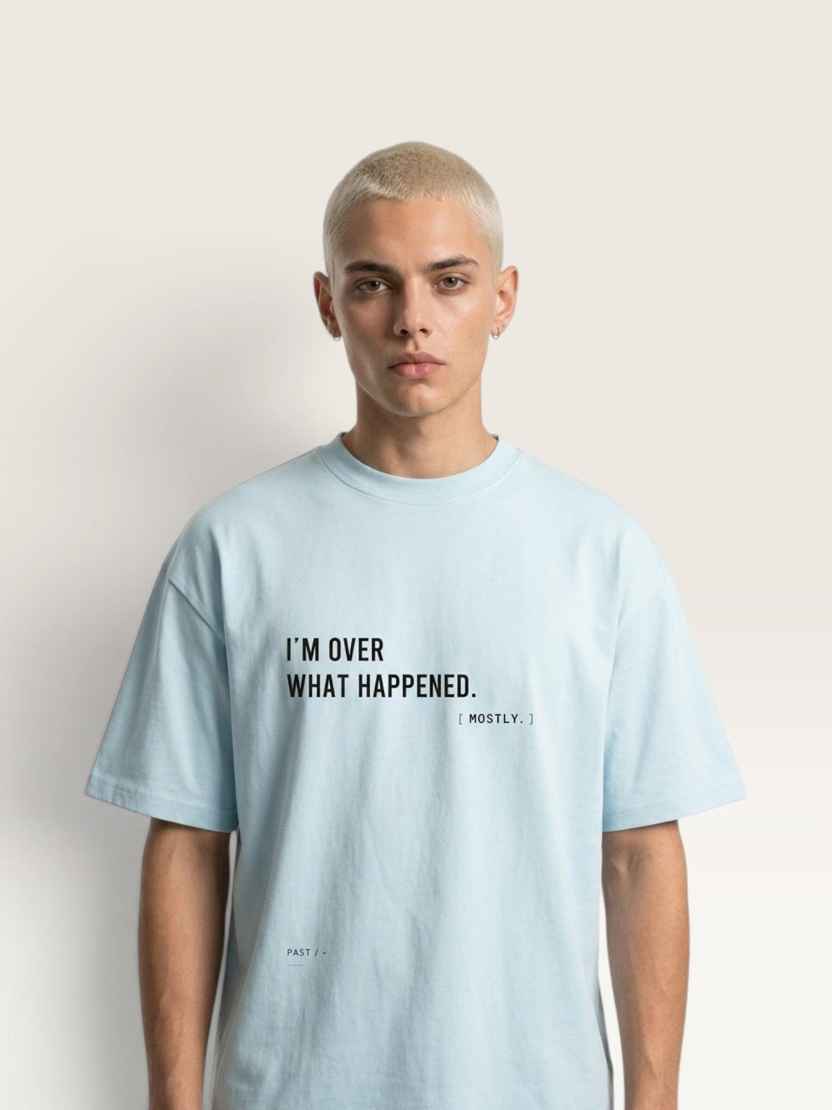 WEARCAPTION oversized light blue heavyweight cotton t-shirt with I'M OVER WHAT HAPPENED text print on a male model