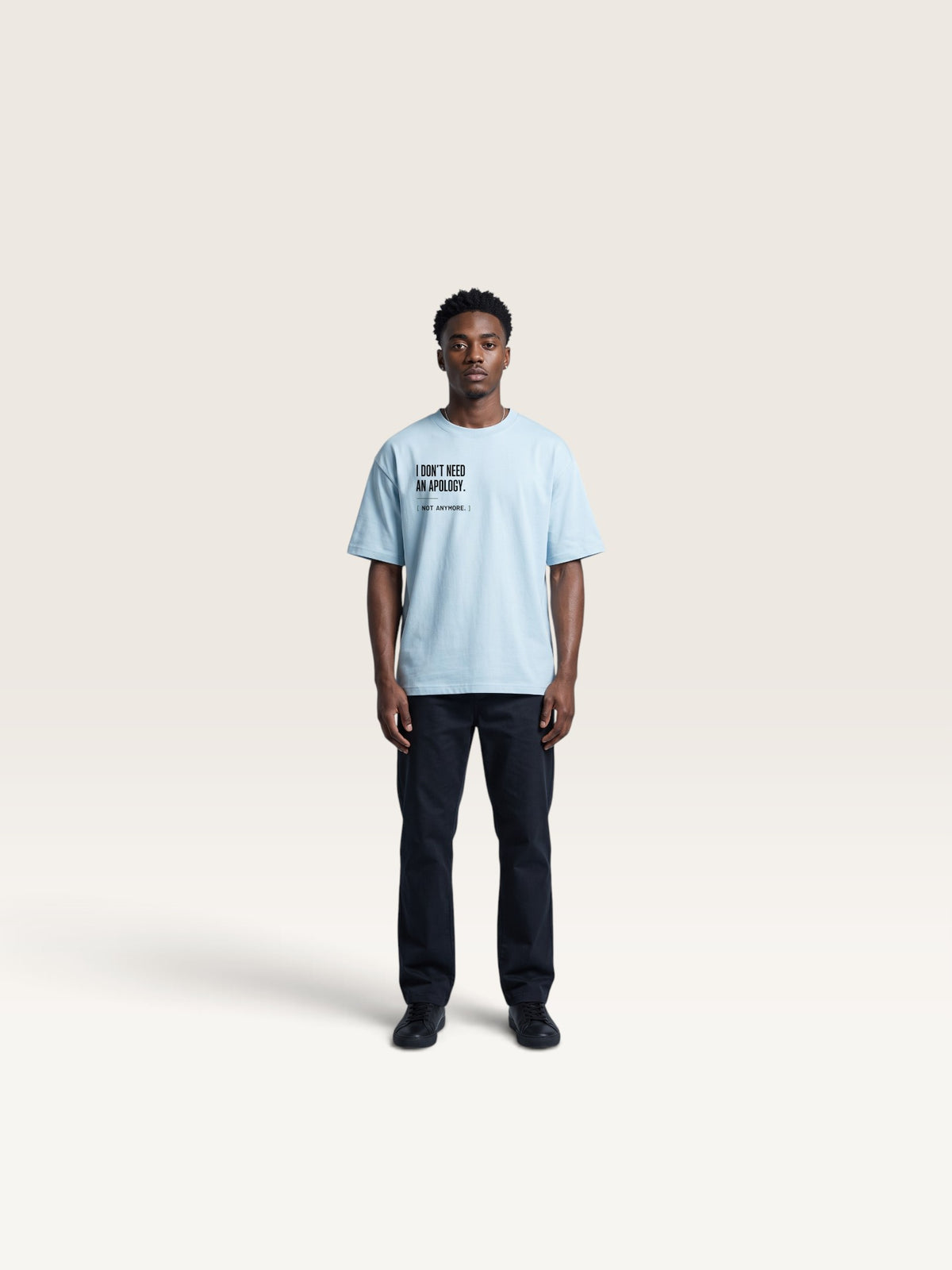 Sky Blue WEARCAPTION light blue heavyweight cotton t-shirt with I DON'T NEED AN APOLOGY text on chest worn by a man