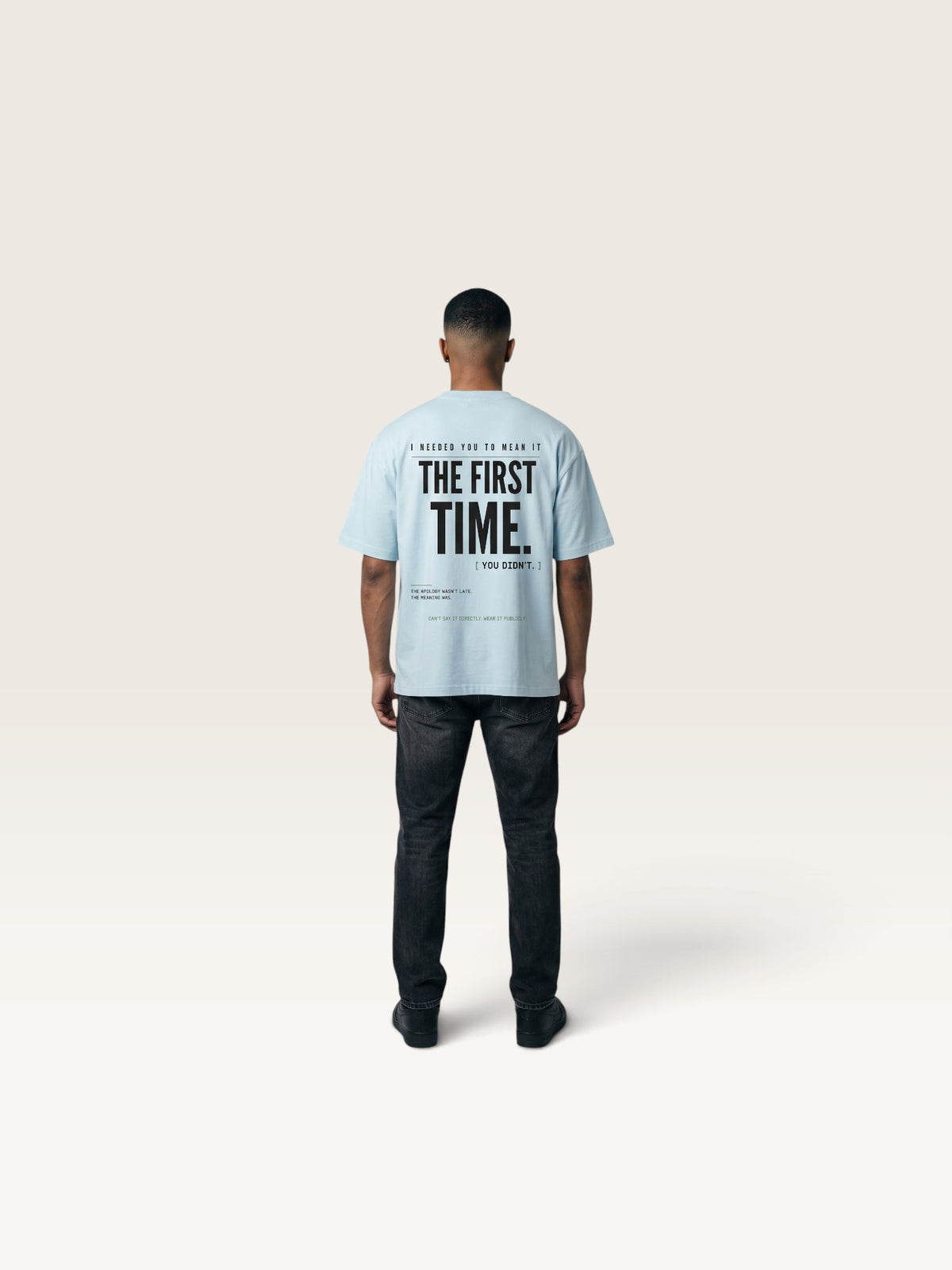 Sky Blue WEARCAPTION light blue heavyweight cotton oversized t-shirt with bold black typography on the back, worn by a man.