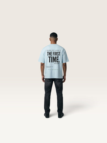 Sky Blue WEARCAPTION light blue heavyweight cotton oversized t-shirt with bold black typography on the back, worn by a man.
