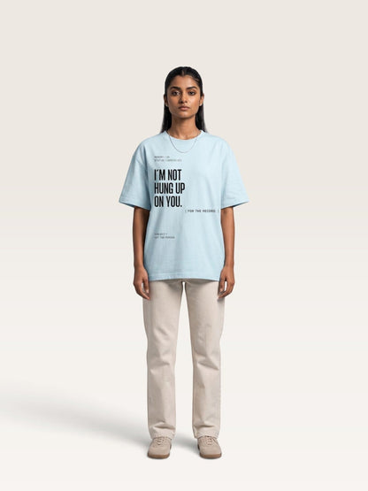 Sky Blue A model wearing a WEARCAPTION light blue oversized heavyweight cotton t-shirt with black text graphic on the front.