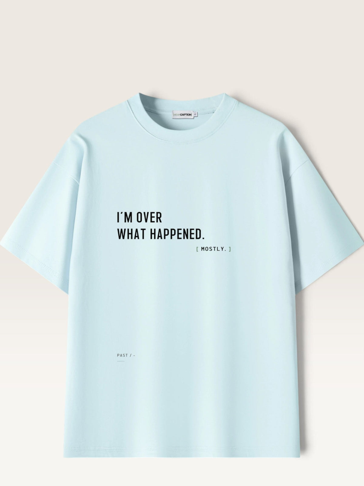 WEARCAPTION light blue heavyweight cotton oversized t-shirt with black text I'M OVER WHAT HAPPENED on the front