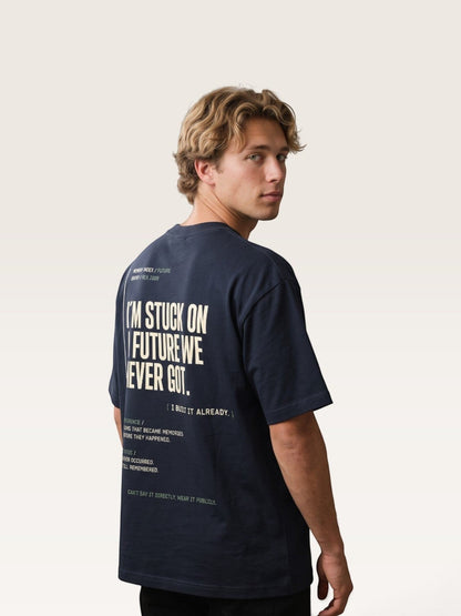 Navy blue WEARCAPTION heavyweight cotton oversized t-shirt with white graphic text on the back worn by a man
