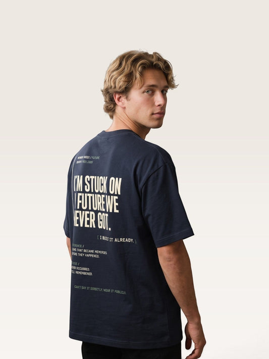 Navy blue WEARCAPTION heavyweight cotton oversized t-shirt with white graphic text on the back worn by a man