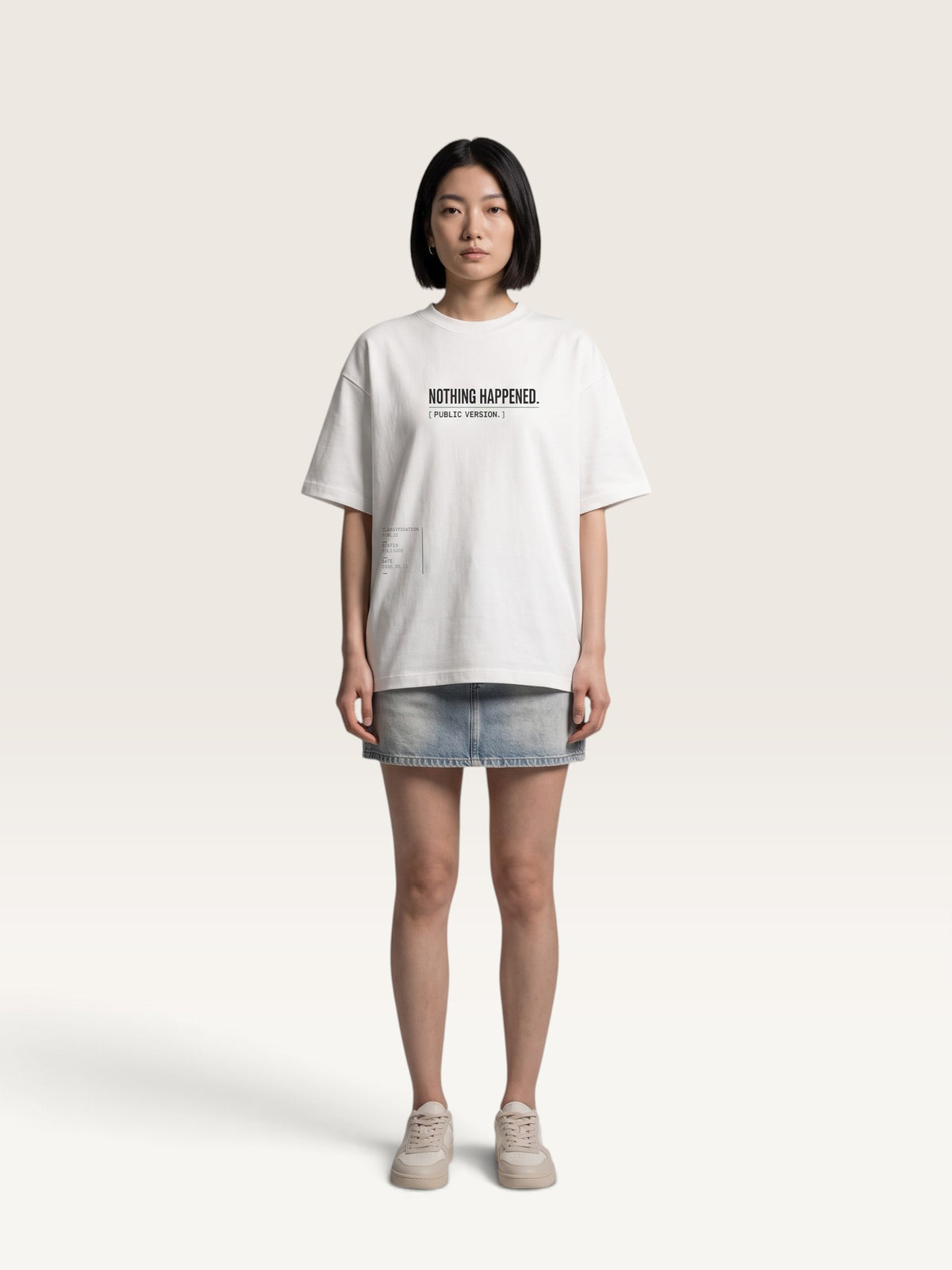 WEARCAPTION Nothing Happened oversized white heavyweight cotton t-shirt with black text on a model