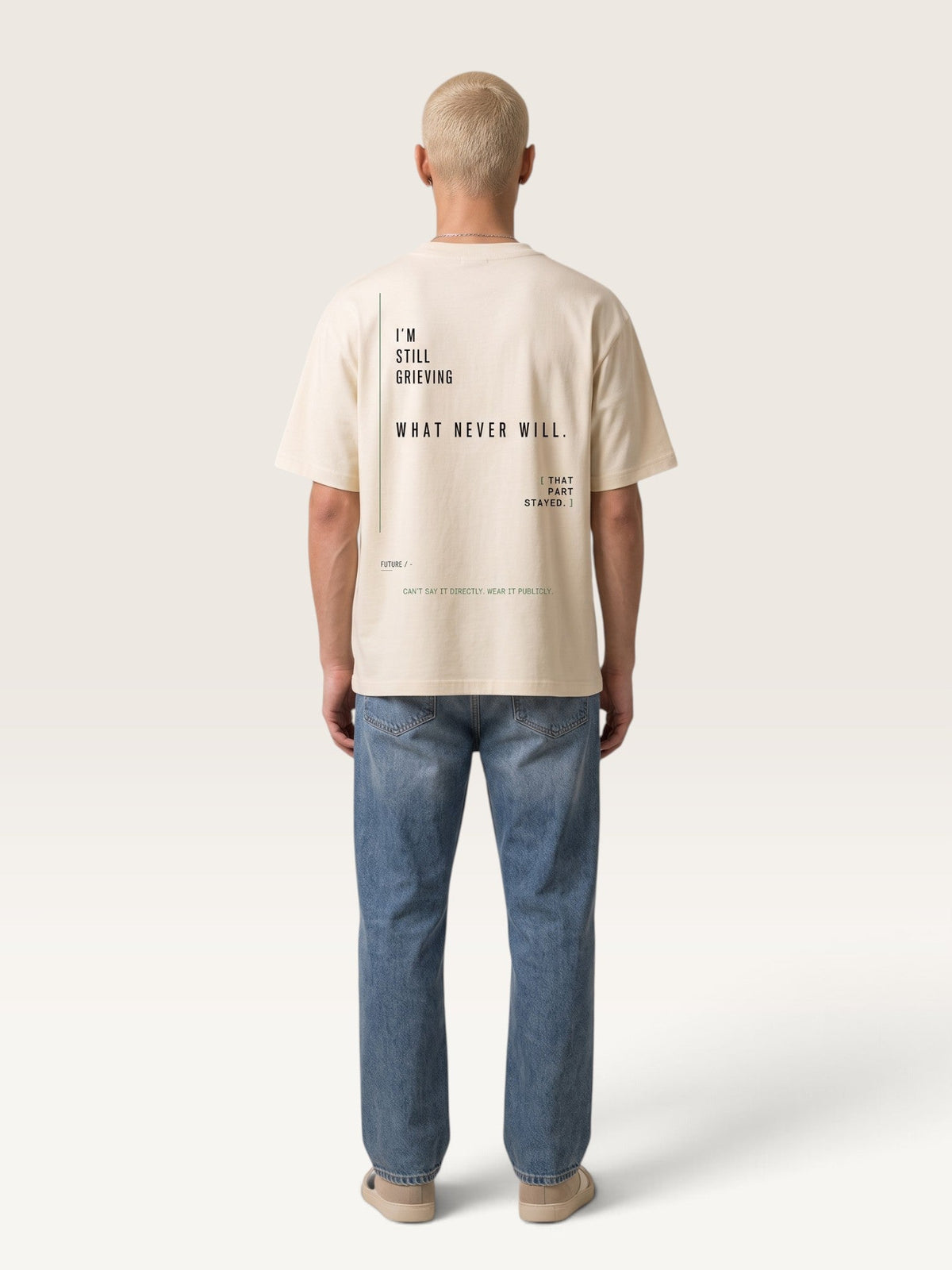WEARCAPTION oversized cream heavyweight cotton t-shirt with black typographic print on the back, worn by a man.