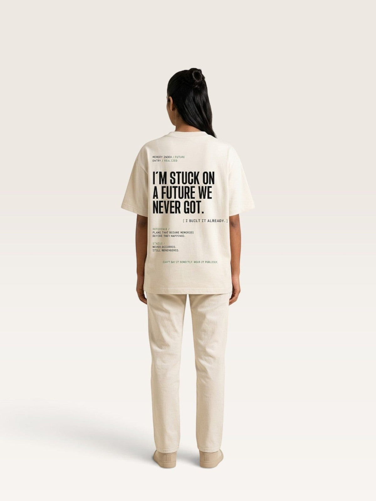 Mild Apricot WEARCAPTION oversized cream heavyweight cotton t-shirt with black typographic print on the back, worn by a model.