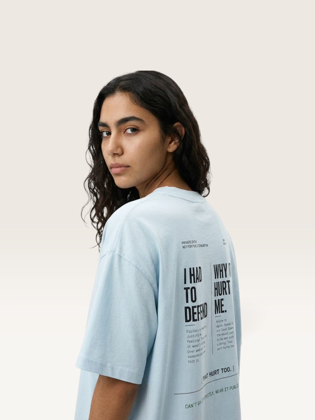 Sky Blue WEARCAPTION oversized light blue heavyweight cotton t-shirt with black typographic back print worn by a woman