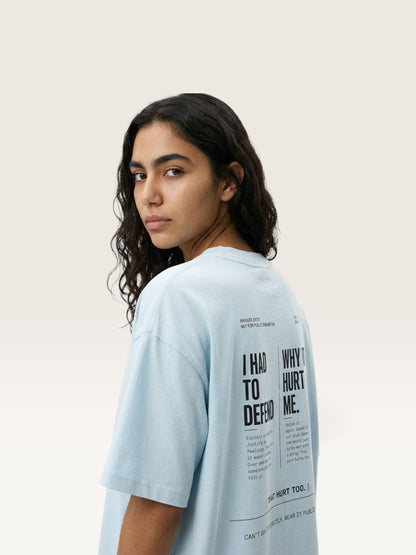 Sky Blue WEARCAPTION oversized light blue heavyweight cotton t-shirt with black typographic back print worn by a woman