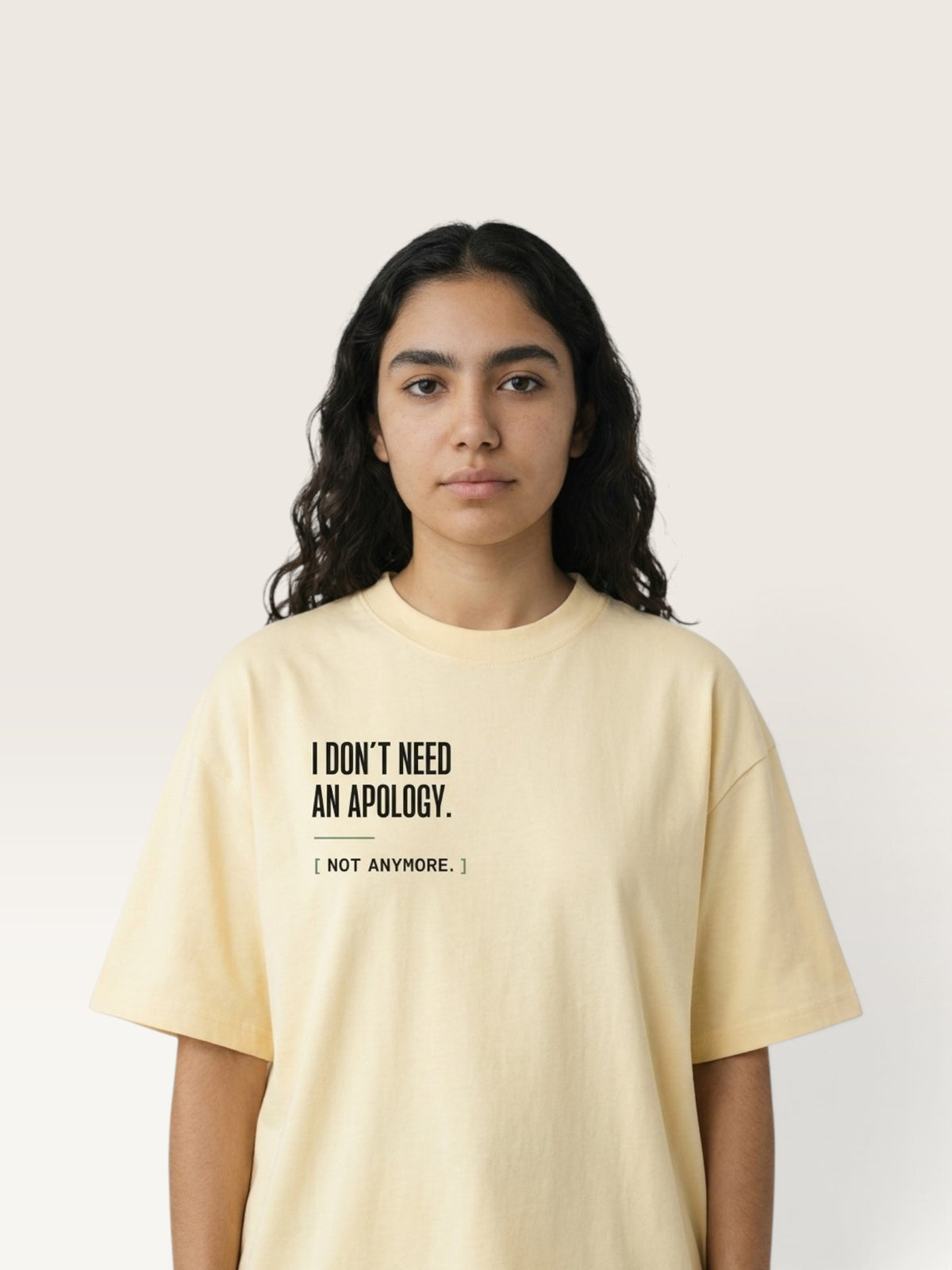 Apricot WEARCAPTION oversized pale yellow heavyweight cotton t-shirt with I DON'T NEED AN APOLOGY text on the chest