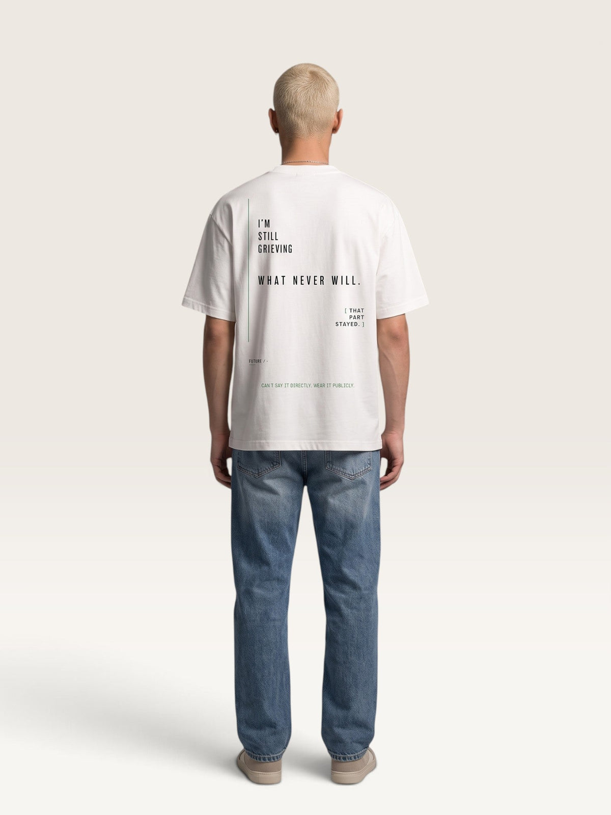 WEARCAPTION heavyweight white cotton oversized t-shirt with black typographic print on the back, worn by a man.