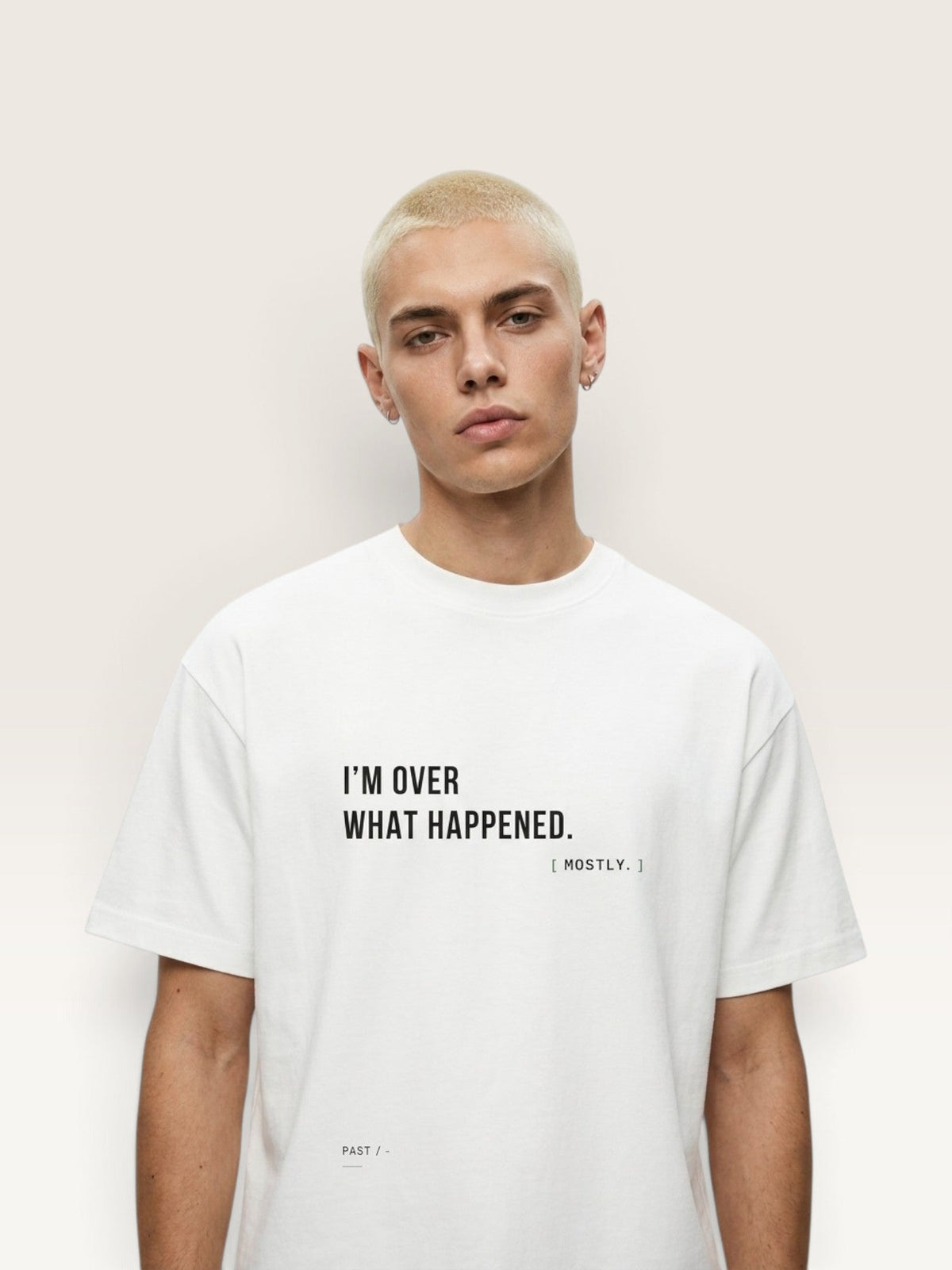 WEARCAPTION white heavyweight cotton oversized t-shirt with black I'M OVER WHAT HAPPENED text on a male model