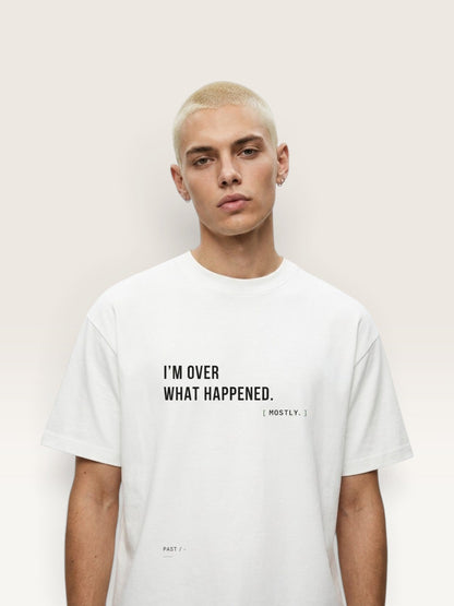 WEARCAPTION white heavyweight cotton oversized t-shirt with black I'M OVER WHAT HAPPENED text on a male model