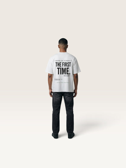 White WEARCAPTION white heavyweight cotton oversized t-shirt with black graphic text on the back, worn by a man.