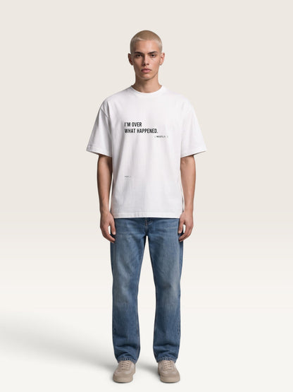 WEARCAPTION white heavyweight cotton oversized t-shirt with black text print on front, worn by a male model.