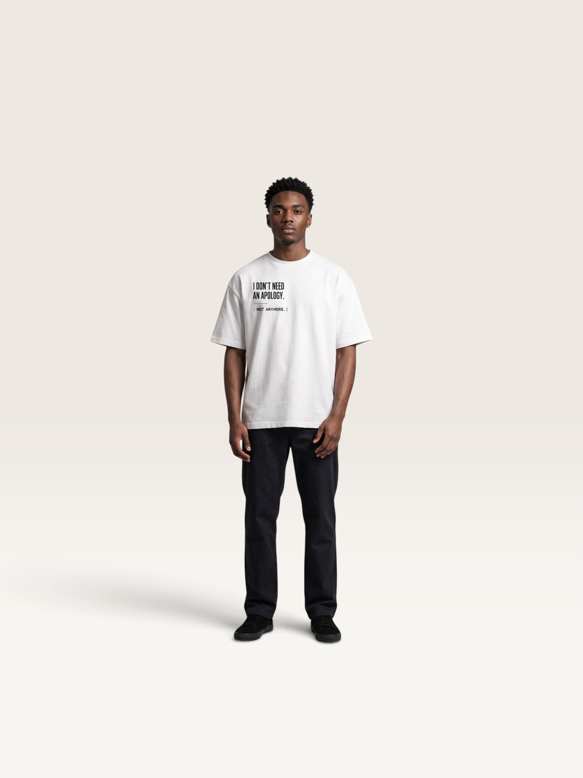 White WEARCAPTION white heavyweight cotton oversized t-shirt with black front text graphic worn by a young man